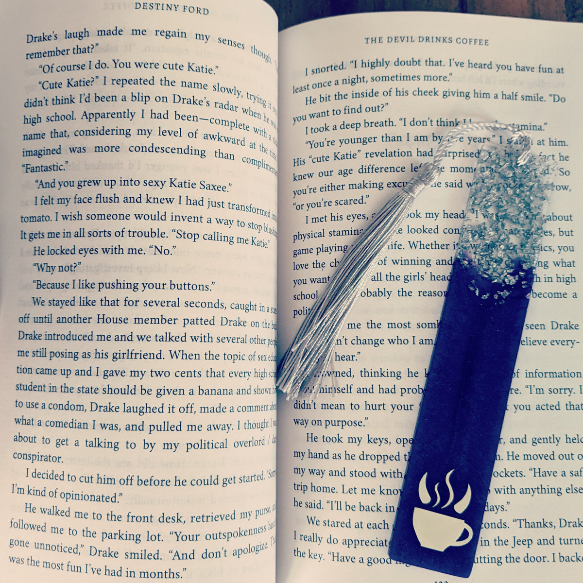 A purple bookmark inside of the book "The Devil Drinks Coffee"