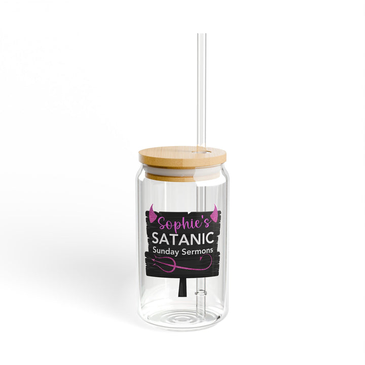 A clear tempered glass with a straw and a printed text &