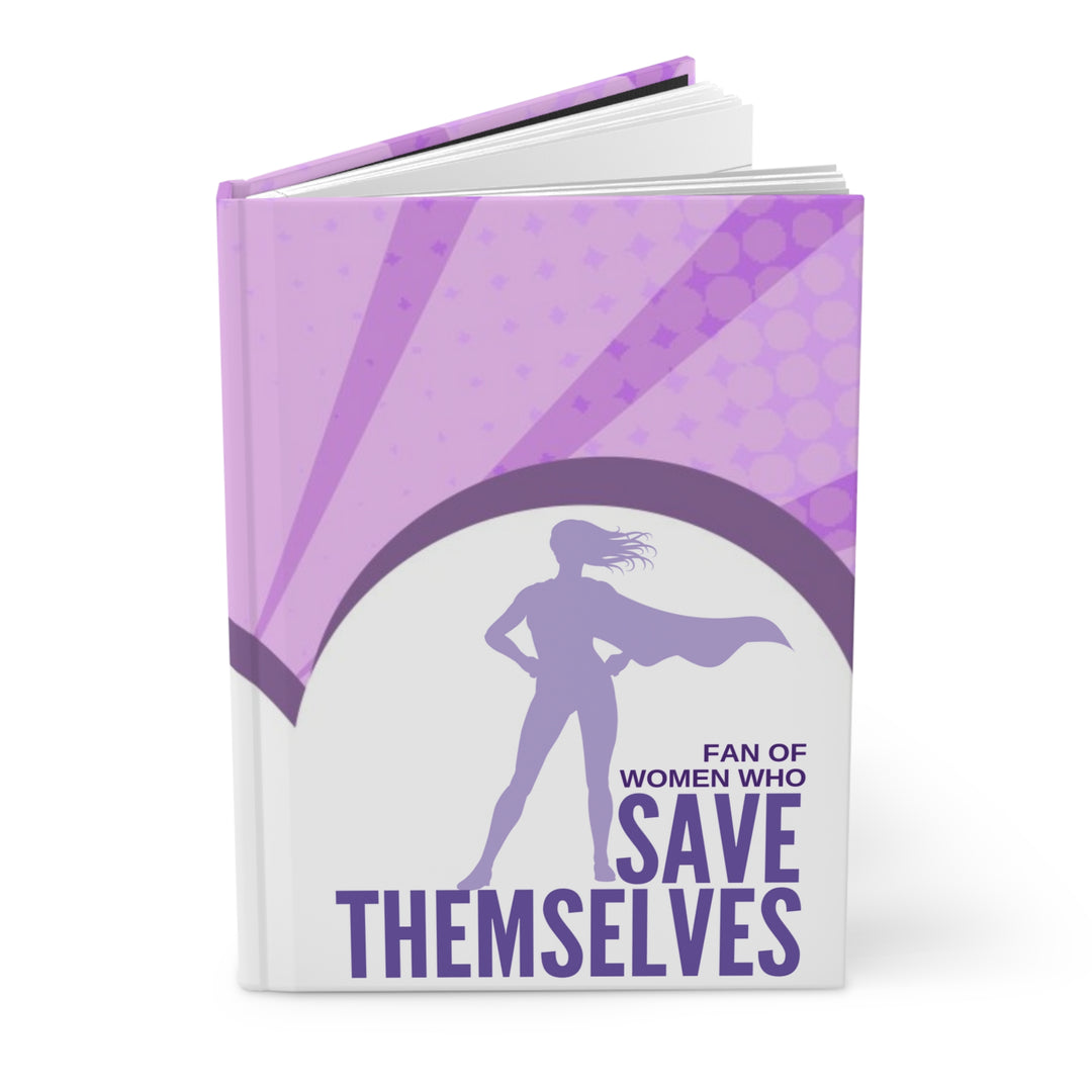 A journal with a purple and white cover featuring a silhouette of a woman superhero and the text &