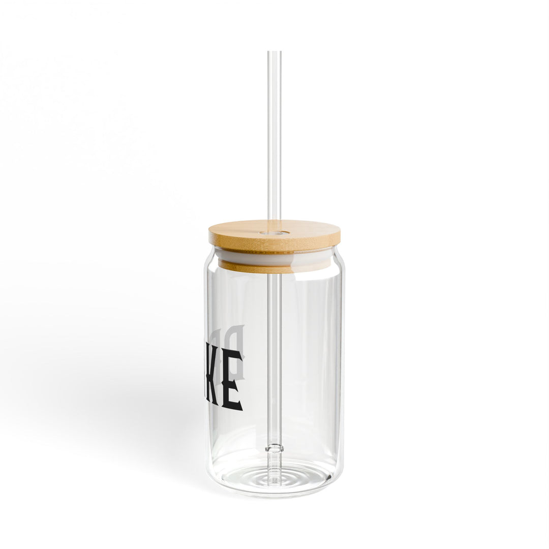 Clear tumbler with wooden lid and straw on a white background