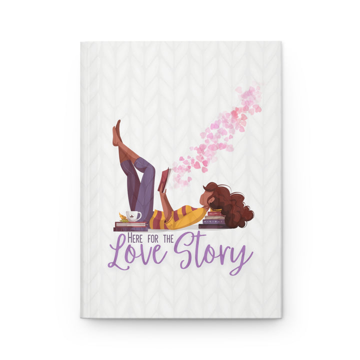 A hardcover journal with a white cover featuring a cartoon illustration of a woman reading a book, with the title &