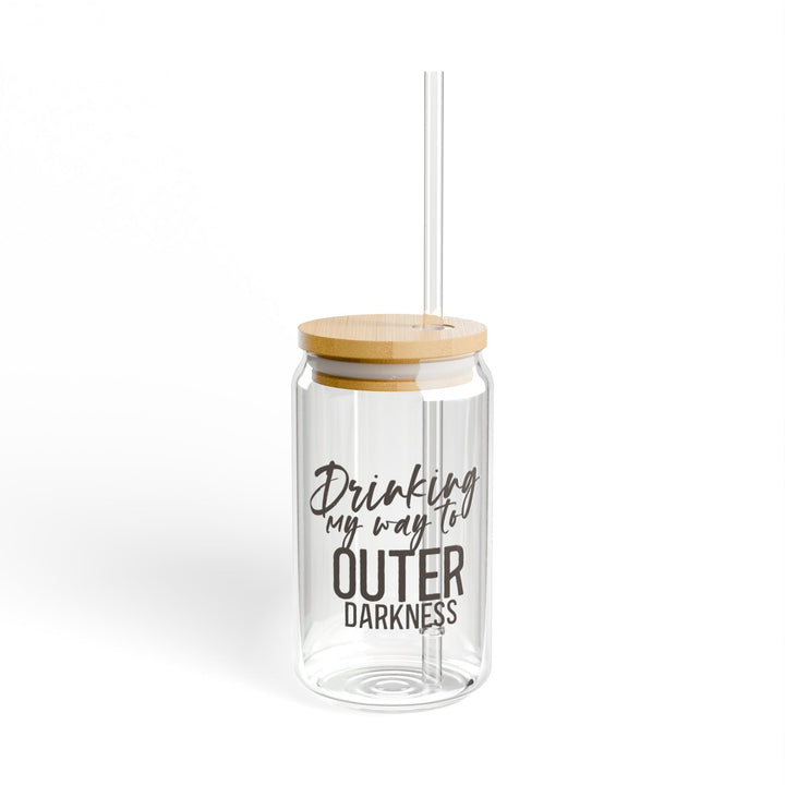 A clear tempered glass sipper with a bamboo lid and a plastic straw, featuring text that reads &