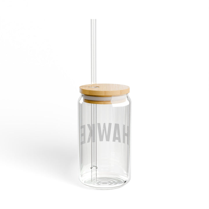 Clear glass tumbler with wooden lid and straw on a white background