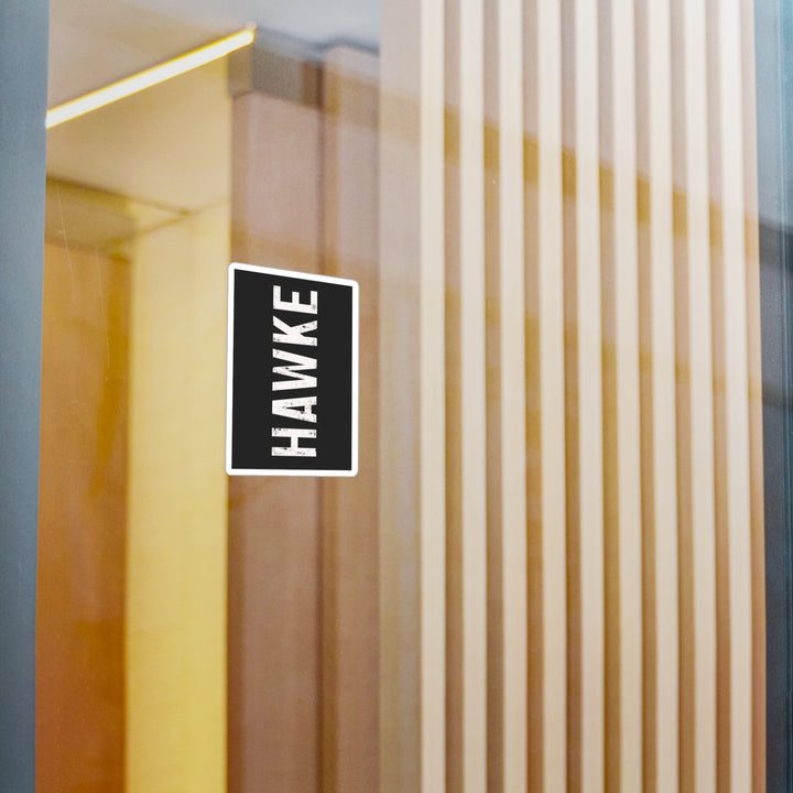 Hawke logo on a glass door with vertical blinds