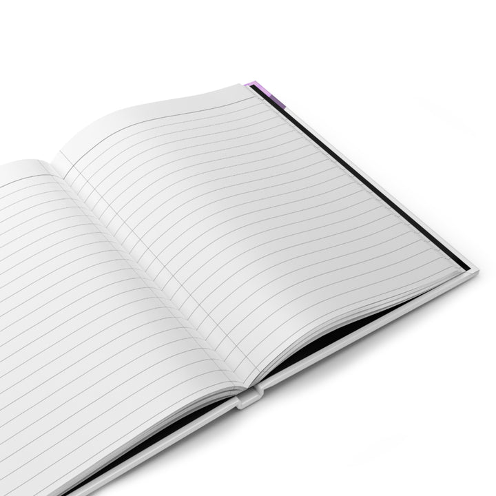 A journal with a purple and white cover featuring a silhouette of a woman superhero and the text &