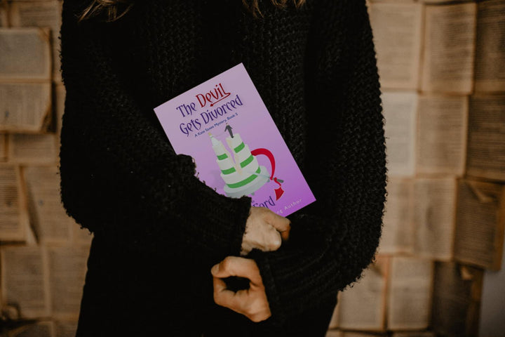Person holding a book titled &