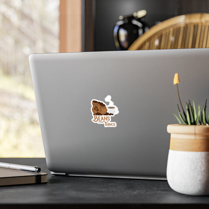 A sticker with an illustration of a cup of coffee and the text &