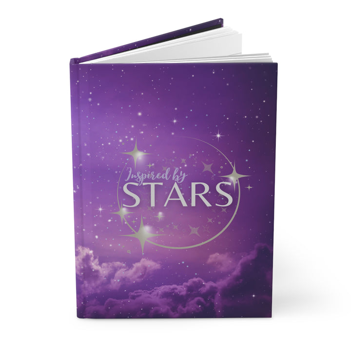 Hardcover journal with a space-themed cover, open to show blank lined pages, with the title &