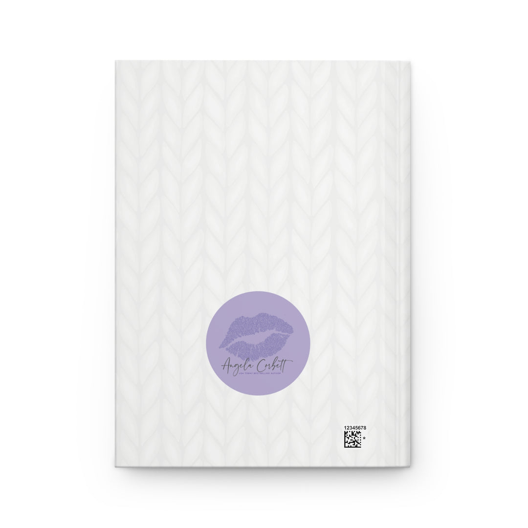 A hardcover journal with a white cover featuring a cartoon illustration of a woman reading a book, with the title &
