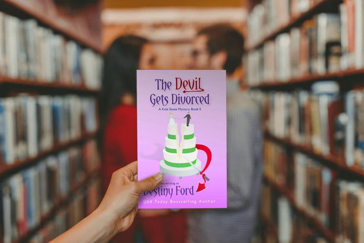 Person holding a book titled &