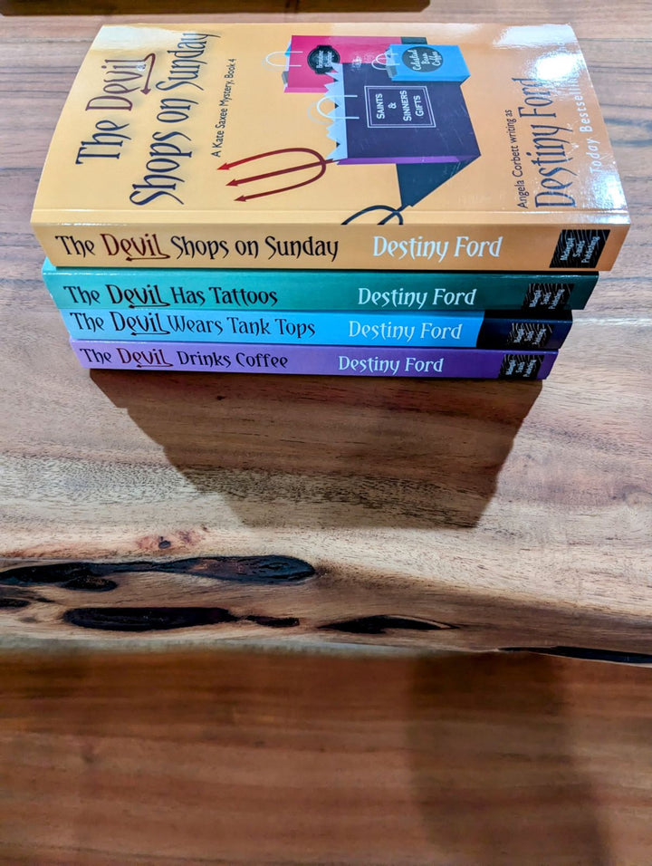 A stack of four paperback books with orange and purple book covers, titled &