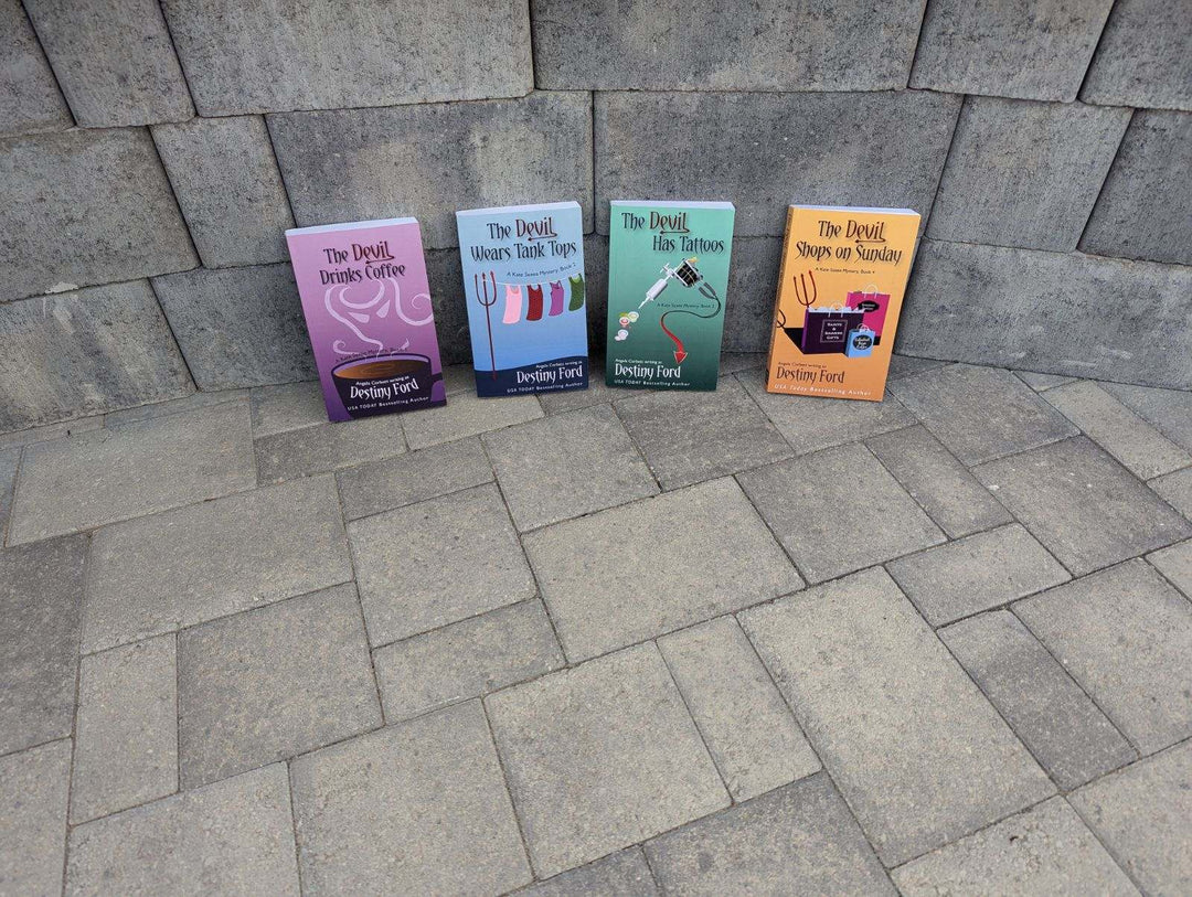 Four paperback books with orange and purple book covers, titled &